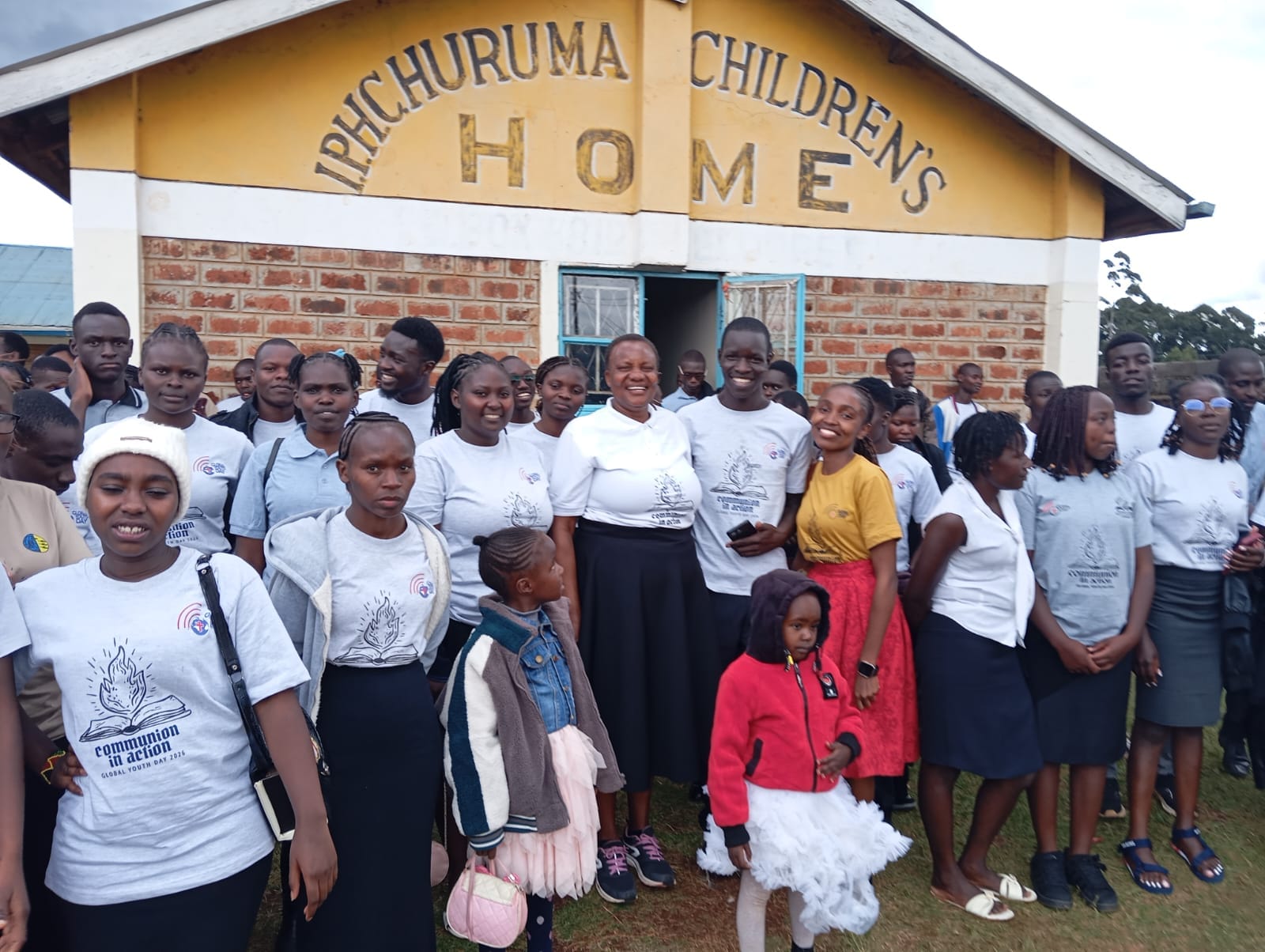 Children and adults gathered outside a community children's home